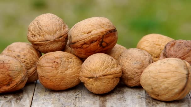 Walnuts on wooden table — Stock Video