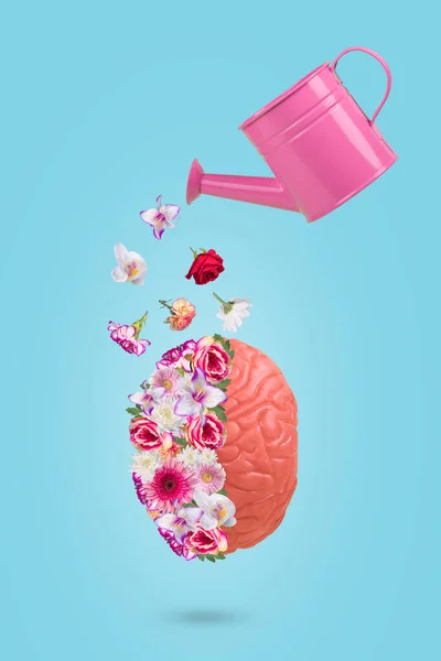 Creative minimal idea made of human brain with flowers and watering can. Conceptual art of Mental Health Awareness, Mental Health Awareness Month, Mental Health and concept for developing positive thinking