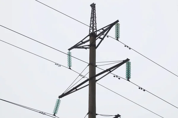 Supports of power lines. Power lines and posts. Detailed close-up.