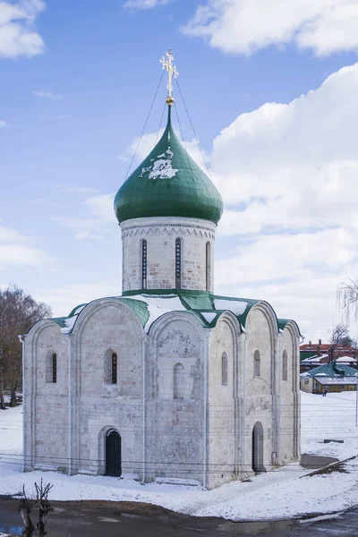 Gold dome of a rural church in Russia with a cross on the background of the spring sky. Cross on the dome of the Orthodox Church against the backdrop of a beautiful sky with clouds. Copy space