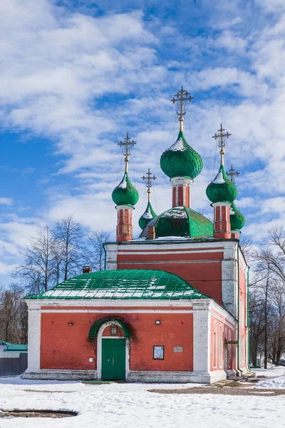 Gold dome of a rural church in Russia with a cross on the background of the spring sky. Cross on the dome of the Orthodox Church against the backdrop of a beautiful sky with clouds. Copy space