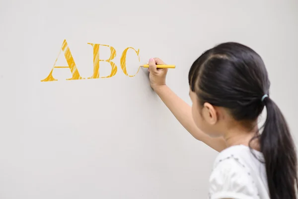 Kid Writing Yellow Abc Wall — Stock Photo, Image