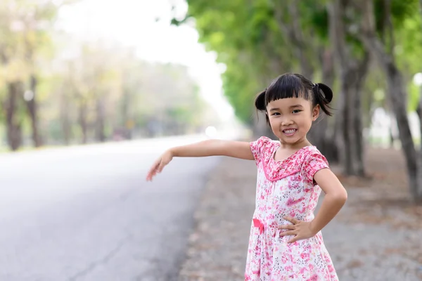 Ребенок машет рукой на обочине дороги — стоковое фото