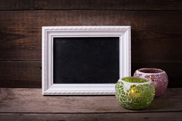 Empty  blackboard and two candles — Stock Photo, Image