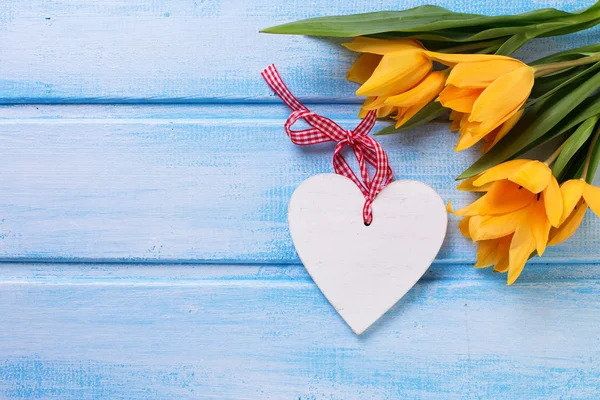 Yellow tulips and decorative heart — Stock Photo, Image