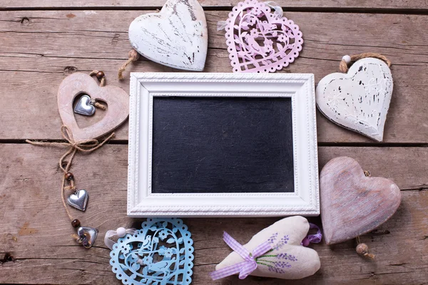 Empty blackboard and decorative hearts — Stock Photo, Image
