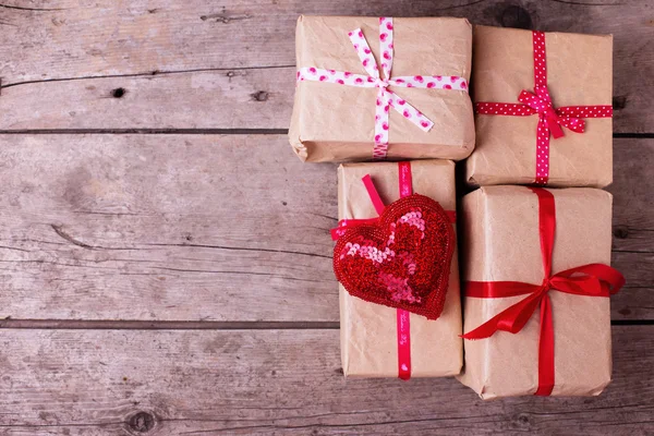 Gift boxes and red decorative heart — Stock Photo, Image