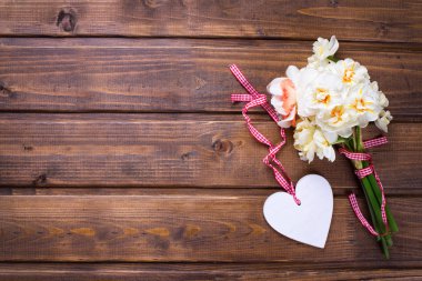 Yellow narcissus flowers and decorative heart  