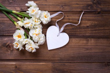 White narcissus flowers and decorative heart 