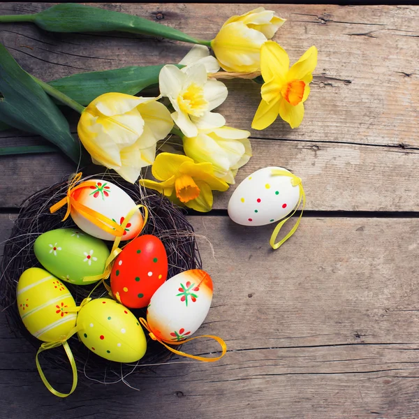 Fresh yellow tulips and decorative eggs — Stock Photo, Image