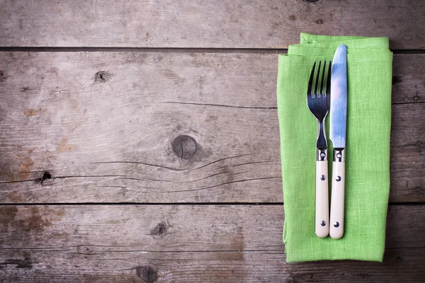 Green napkin with knife and fork — Stock Photo, Image