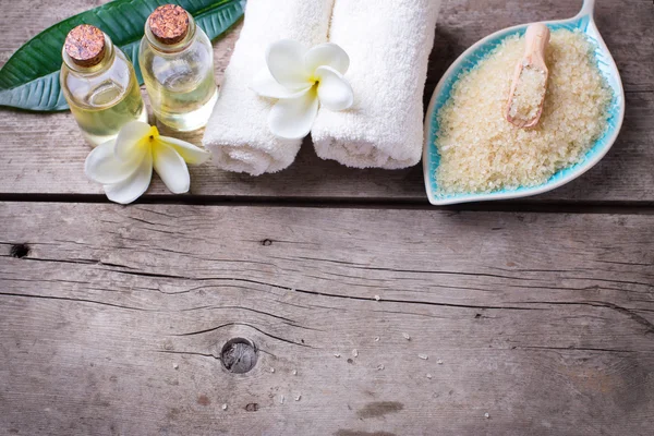 Sea salt and bottles with oil — Stock Photo, Image