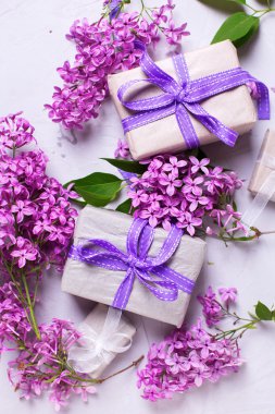 Wrapped gift boxes and lilac flowers 