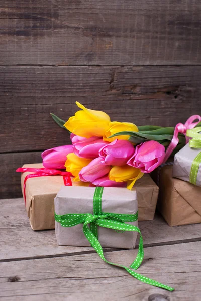 Spring tulips flowers and boxes with presents — Stock Photo, Image