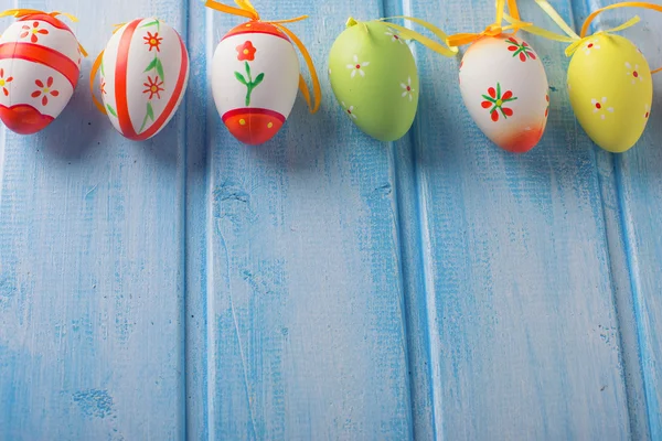 Easter eggs on blue wooden background — Stock Photo, Image