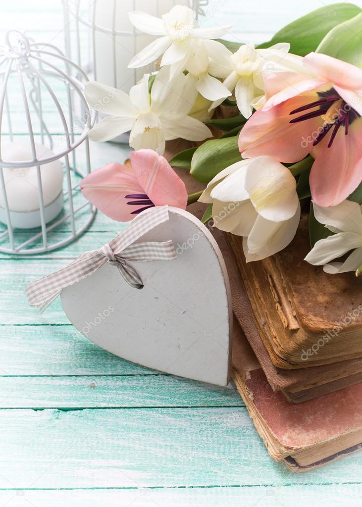 Background with fresh flowers, old books and candles