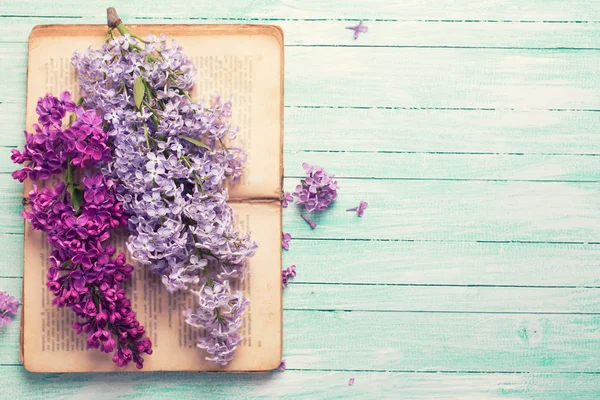 Postcard with lilac flowers and old book — Stock Photo, Image