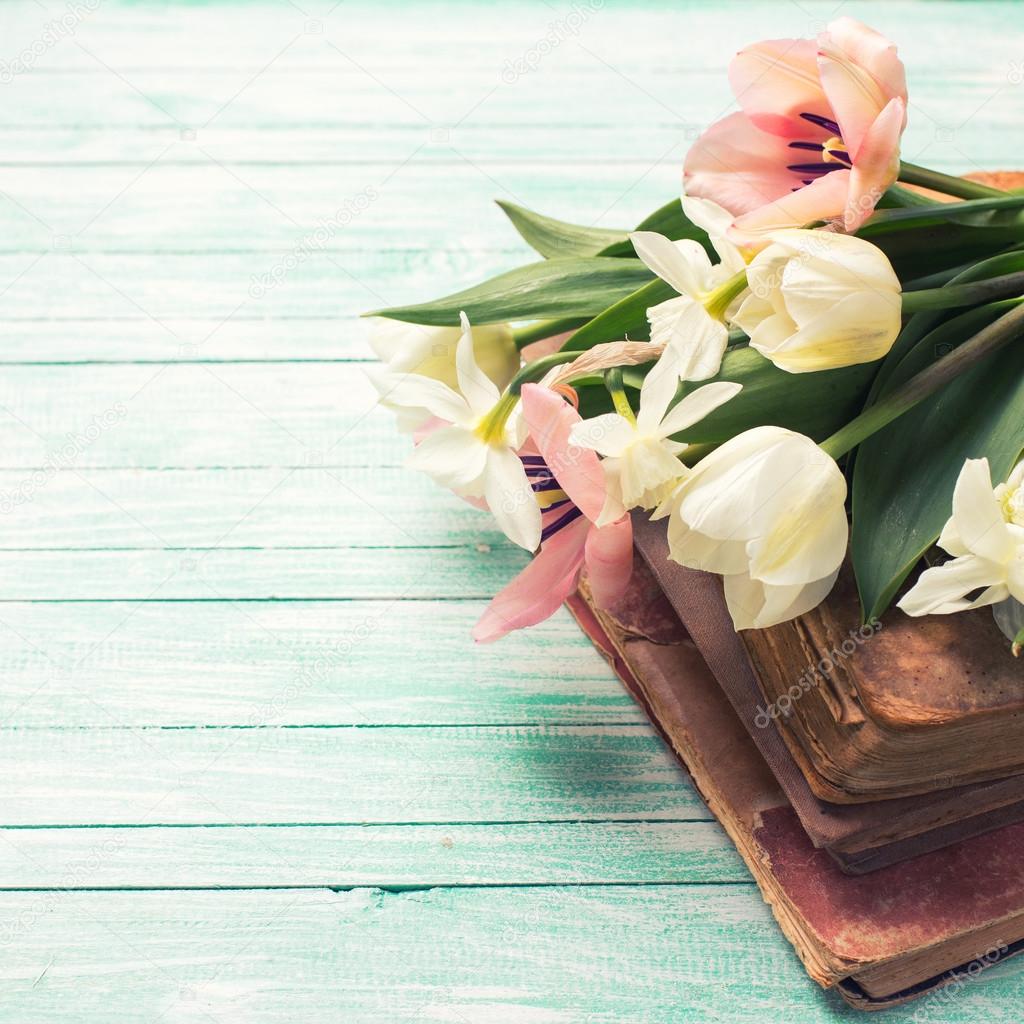Background with fresh flowers and old books