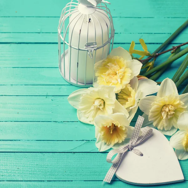 yellow daffodils, candle in bird cage