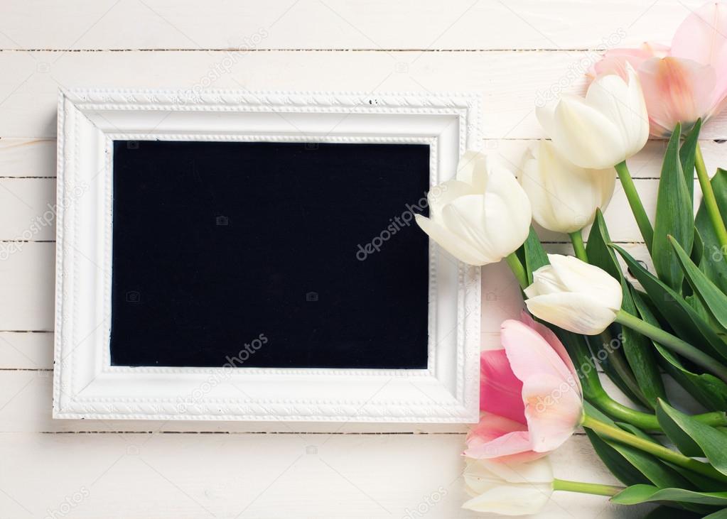 Tulips and empty blackboard.