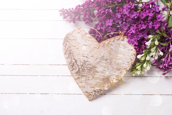 Lilac flowers and decorative heart — Stock Photo, Image