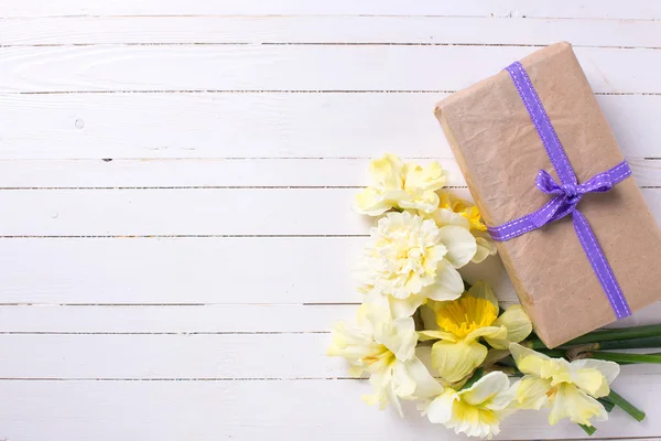 Spring flowers and box with present — Stock Photo, Image