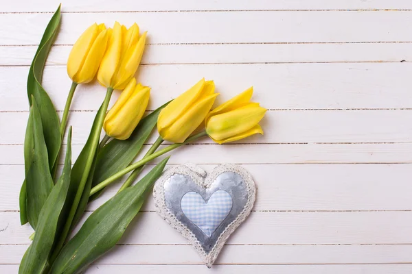 Yellow  tulips and decorative heart — Stock Photo, Image