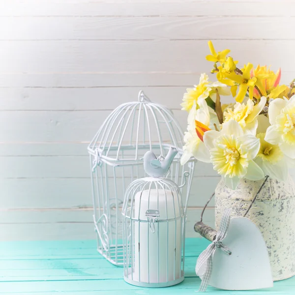 Flowers and candle in cage — Stock Photo, Image