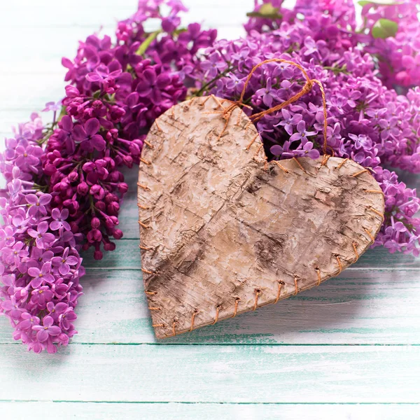 Lilac flowers and decorative heart — Stock Photo, Image