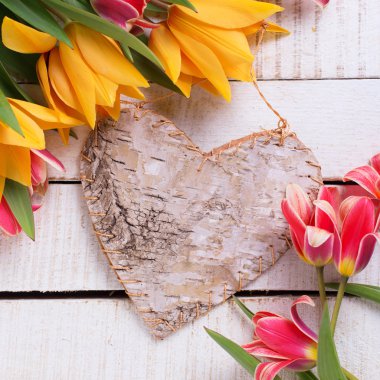 yellow tulips  and rustic decorative heart