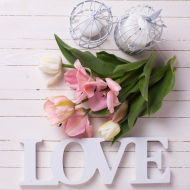 white and pink  tulips with candles