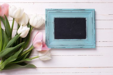 white and pink flowers and empty blackboard