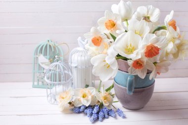 narcissus,  white tulips flowers and candles