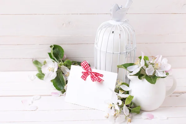 Apple blossom and candle in decorative cage — Stock Photo, Image