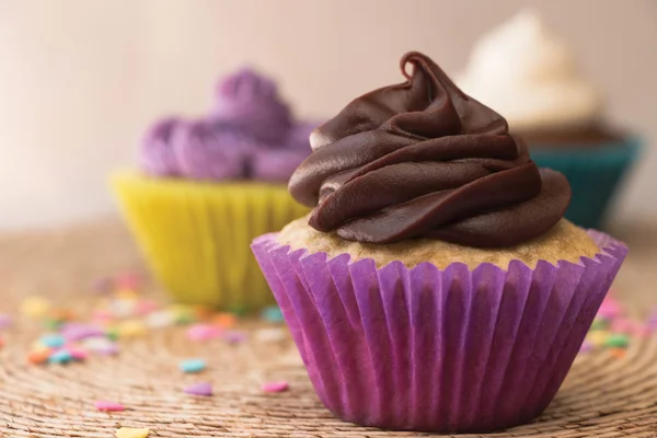 Three cupcakes with frosting — Stock Photo, Image