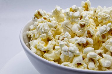 Beyaz arka planda izole edilmiş bir kase patlamış mısır 