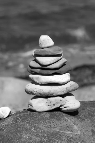 Stone tower on a big rock. Black and white.