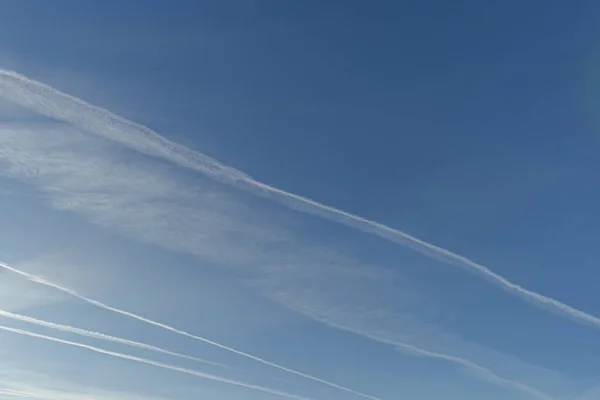 White airplane stripes on a blue sky