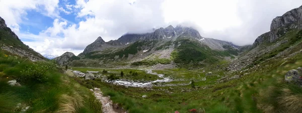 Beautiful panorama of the mountains from the path that leads to the Segantini refuge in the Nambrone valley in Trentino, travel and landscapes in Italy