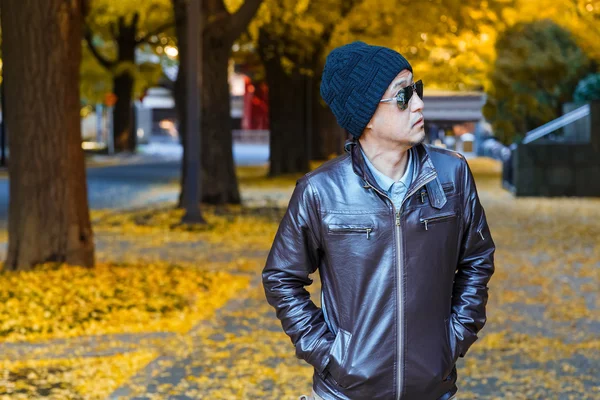 An asain man in a brown jacket — Stock Photo, Image