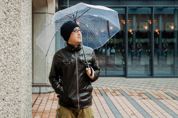 An Asian Man in a Brown Jacket  With a Clear Umbrella — Stock Photo, Image