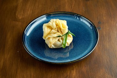 Doyuruculu Ukrayna Blini 'si ahşap arka planda mavi bir tabakta servis ediliyor. Flatjack gözlemesi