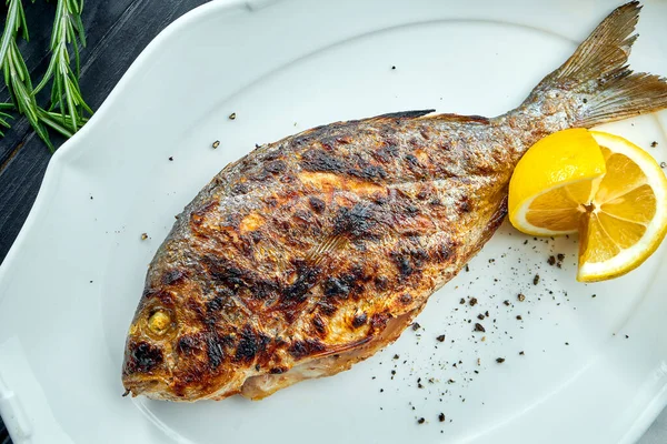 Appetizing Grilled Dorado Charcoal Lemon Served White Plate Dark Wood — Stock Photo, Image