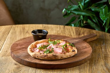 Tahta tahtada mortadela, roka ve şam fıstıklı pizza. İtalyan Mutfağı