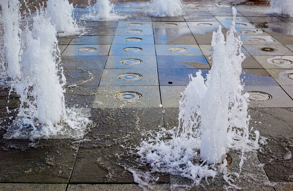 Background. Water splashes in the city fountain close up.Selective focus