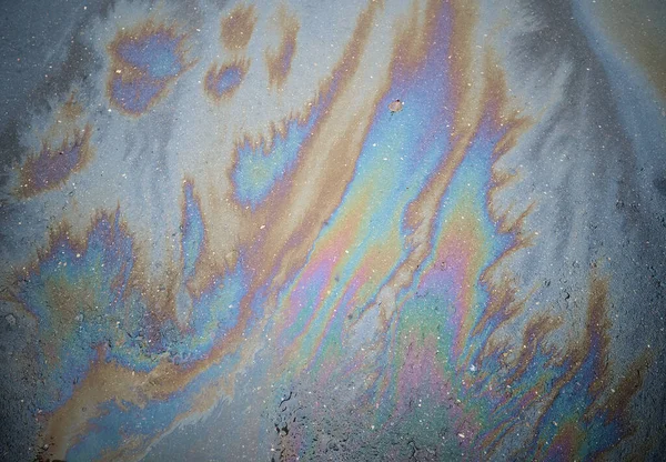 Beautiful abstract colorful background, texture, stains from engine oil on the asphalt.Colorful gas stain on wet asphalt.