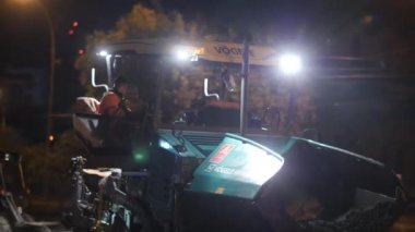 Novosibirsk region, September 7, 2019. Asphalt paver with flashing lights. Road repair, construction of a new road in the city. 