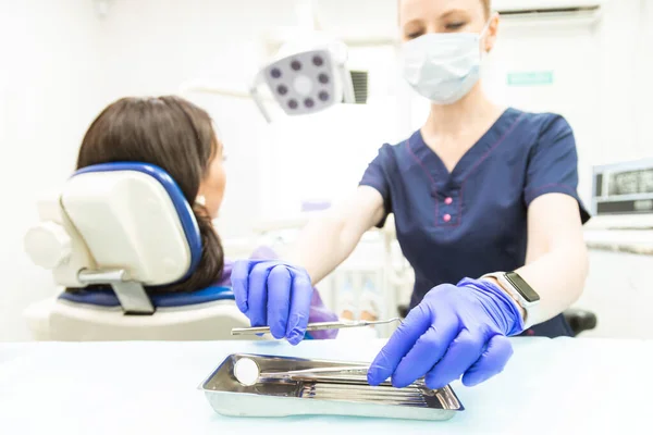 Conceito de Odontologia. Serviços odontológicos profissionais e equipamentos modernos sem dor. O médico consulta e trata a jovem, realiza um exame e elabora um plano de tratamento. — Fotografia de Stock