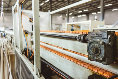 Plastik boru üretmek için ekstrakarların olduğu bir atölye. Su tedarik ve gaz borularından yüksek hızda ekstrüzyon hattı. Üretim tesisi.