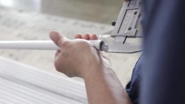 Fabrika mühendisi polipropilen boruların kalitesini kontrol ediyor.